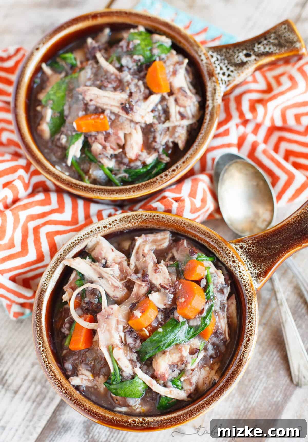 Hearty Slow Cooker Leftover Turkey Wild Rice Stew 2 A steaming bowl of hearty slow cooker turkey and wild rice stew, garnished with fresh herbs, showcasing its rich texture and comforting appeal.