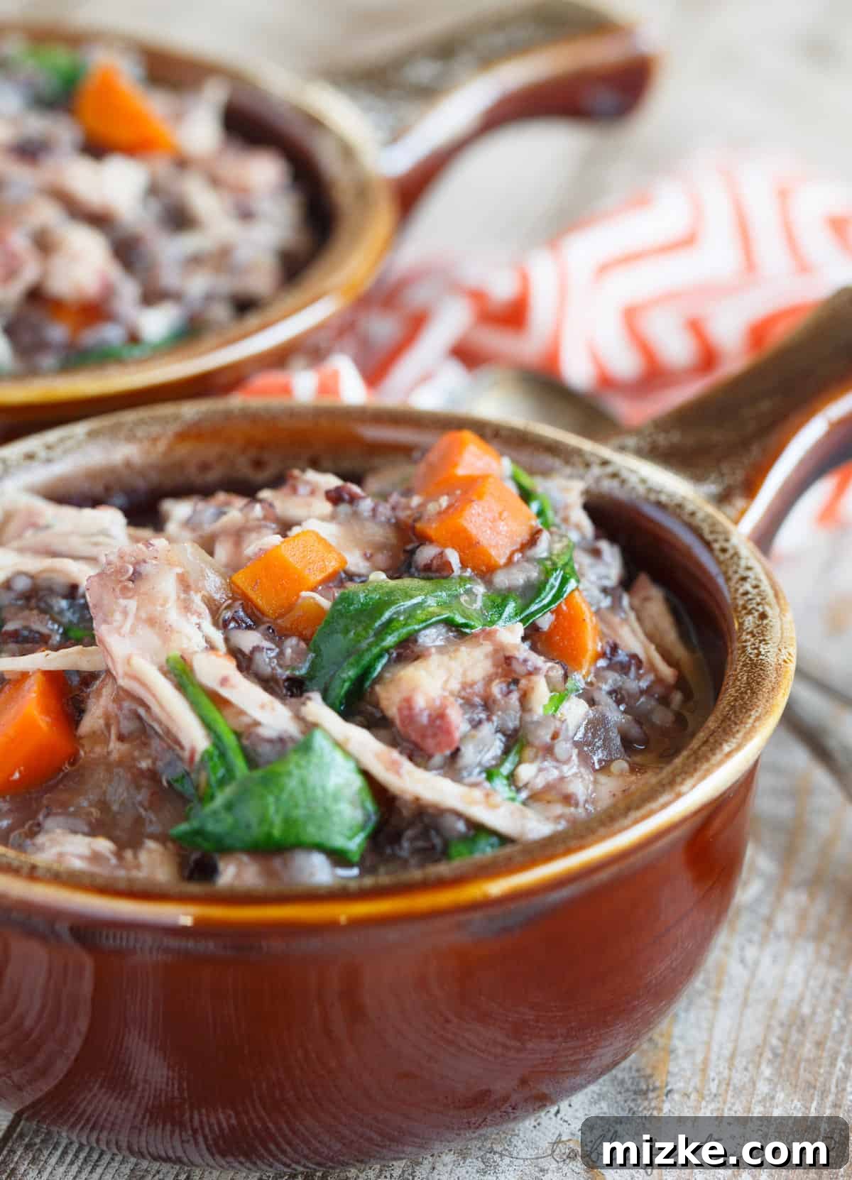 Hearty Slow Cooker Leftover Turkey Wild Rice Stew 3 Close-up of a slow cooker filled with turkey, wild rice, carrots, and onions, simmering gently to create a rich, aromatic stew.