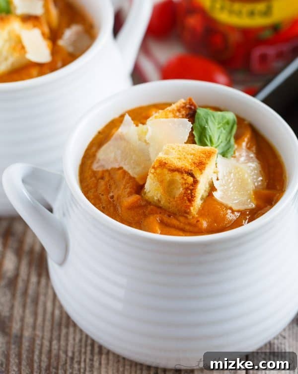 Fire-Kissed Autumn Harvest Soup 2 A beautifully smooth, creamy bowl of fire-roasted tomato, pumpkin, and corn soup, garnished and ready to serve. Made with Hunt's fire-roasted diced tomatoes, it promises a rich, comforting flavor perfect for autumn evenings.