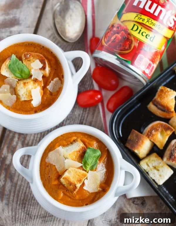 Fire-Kissed Autumn Harvest Soup 3 Close-up of the vibrant orange and yellow hues of the fire-roasted tomato, pumpkin, and corn soup, showcasing its smooth texture and appetizing colors.