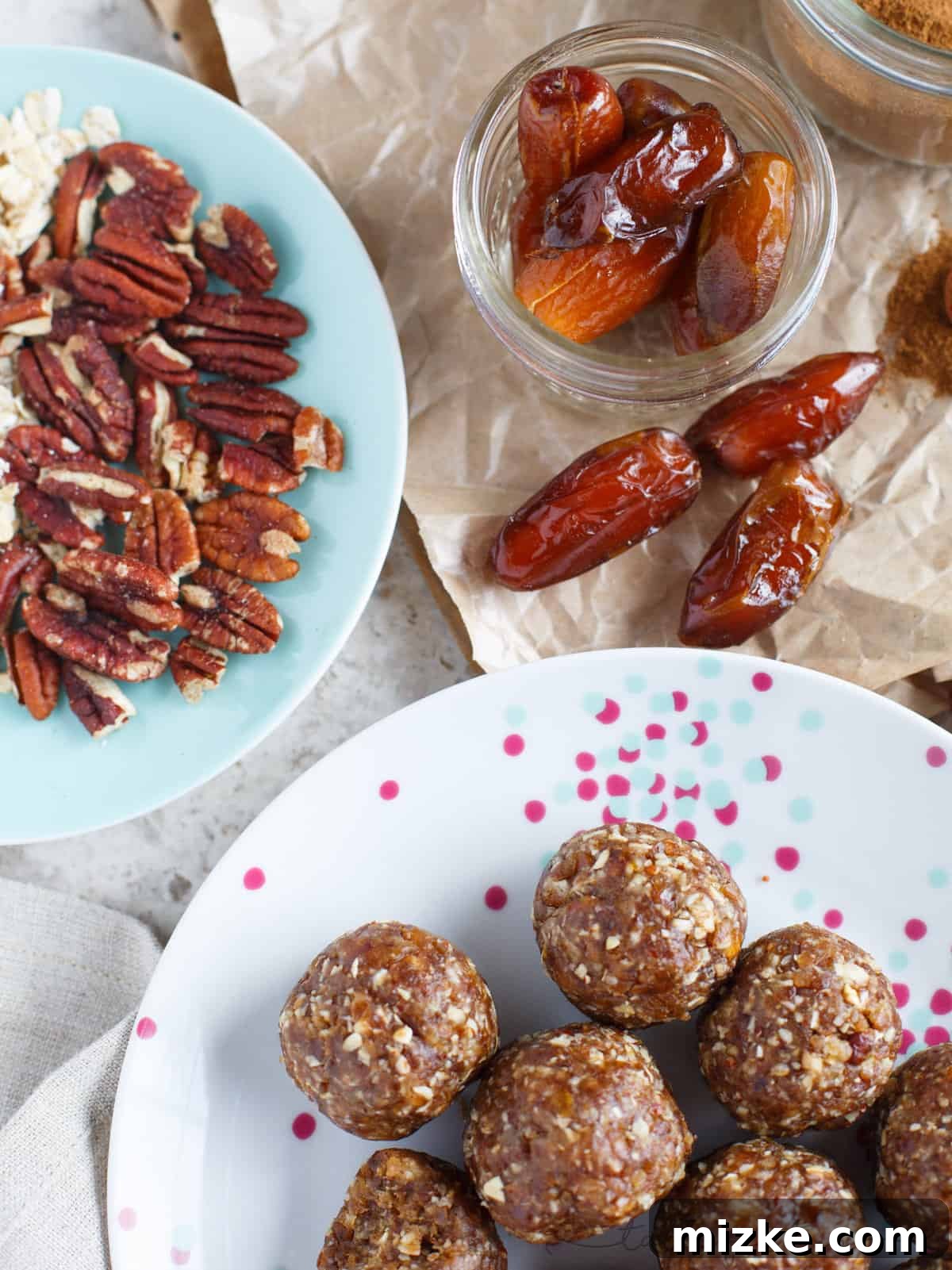 Autumn Glow Energy Bites 5 A single pumpkin pie energy snack ball held gently between two fingers, emphasizing its convenient size and appealing texture.