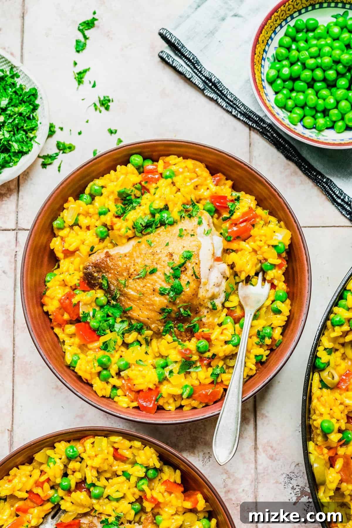 Serving Arroz con Pollo in individual bowls for a delightful meal. Two bowls of Arroz con Pollo, steaming and garnished with parsley, placed on a wooden table, inviting to a comforting meal.