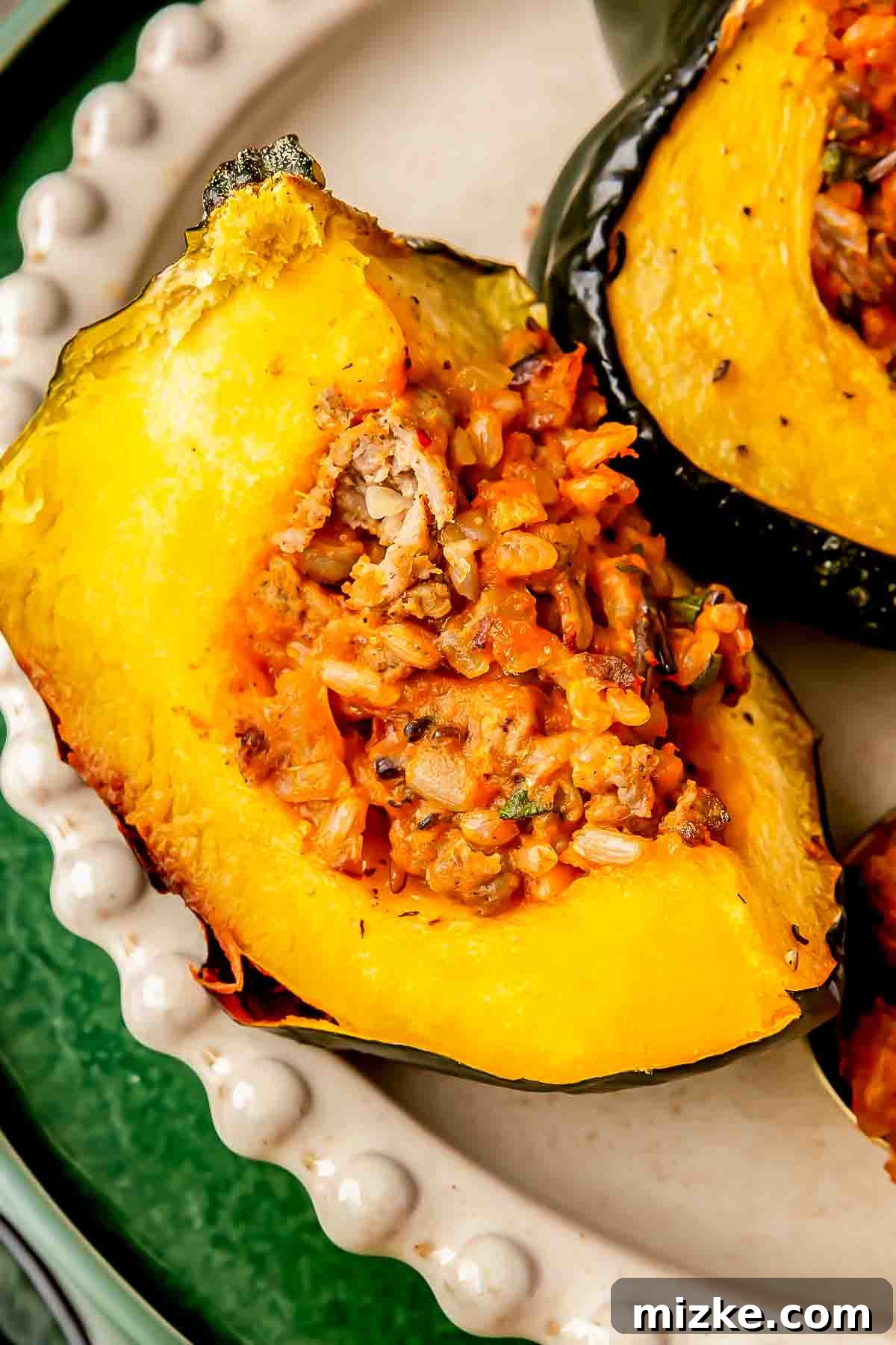 Hearty Stuffed Acorn Squash 4 Close-up of a quartered stuffed acorn squash, showcasing the rich, savory wild rice and vegetable mixture, elegantly presented on a decorative plate.