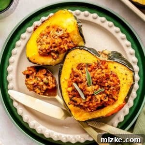 A plate with stuffed acorn squash, filled with rice and herbs. A knife and fork are placed beside the squash.