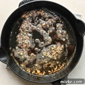 Fiery Cajun Chicken Alfredo 4 minced garlic cooked in butter in a cast iron skillet