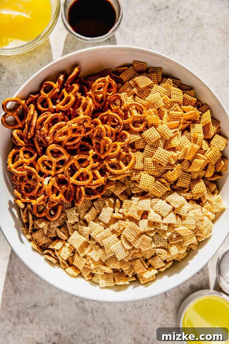 Irresistible Chex Crunch 4 Various Chex cereals and mini pretzels in a large mixing bowl