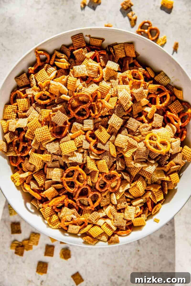 Irresistible Chex Crunch 5 Chex cereals and pretzels gently mixed together in a large bowl, ready for seasoning