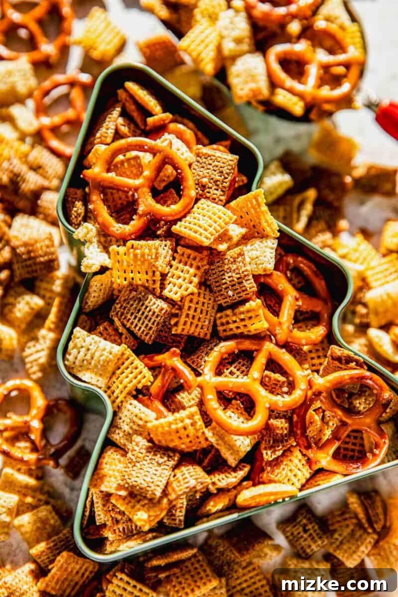 Irresistible Chex Crunch 9 Homemade Chex Mix presented in a festive metal Christmas tree shaped tin, suitable for gifting