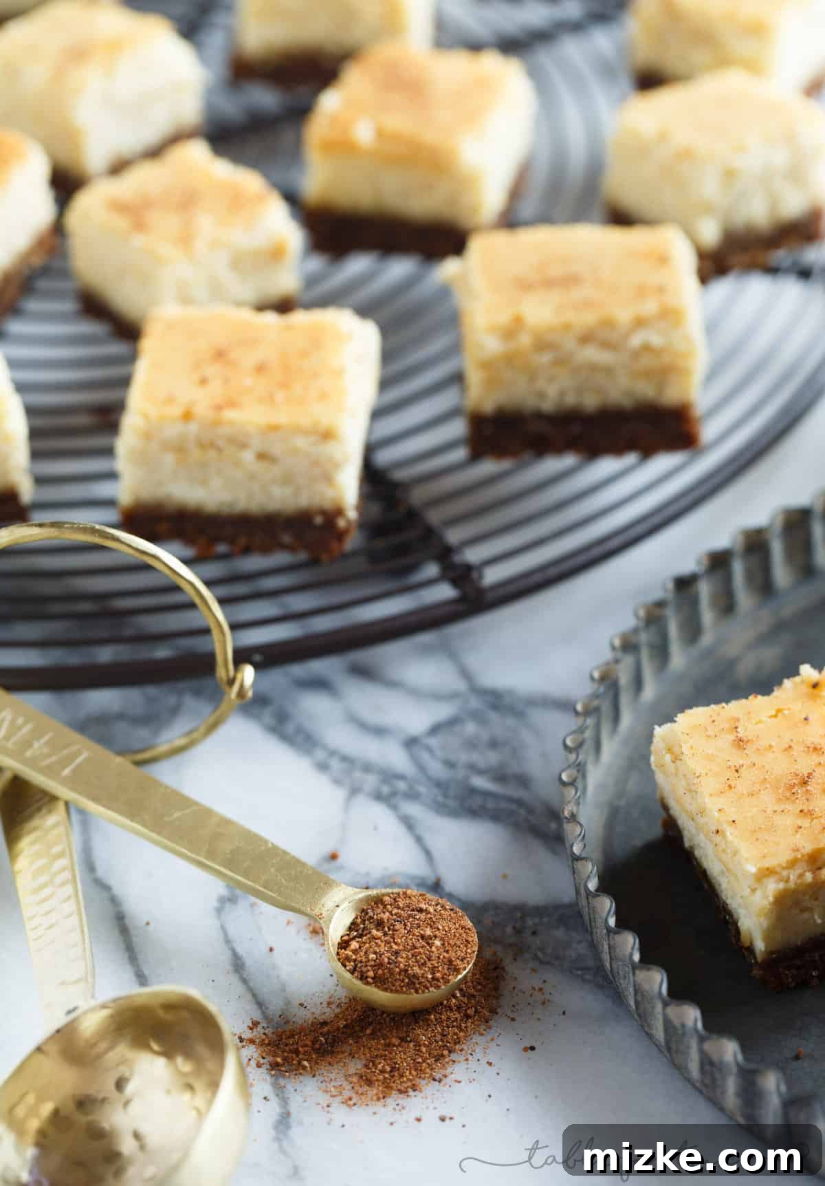 Gingersnap-Crusted Eggnog Cheesecake Bites 4 Close-up shot of an eggnog cheesecake bite, highlighting the golden gingersnap crust and the smooth, rich cheesecake filling.