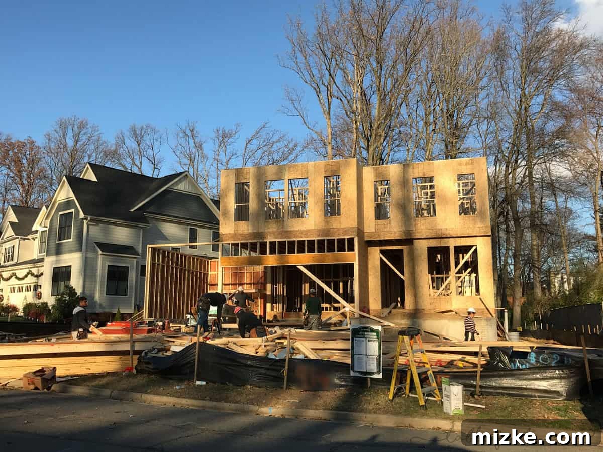 The framing progressing with interior walls and floor joists clearly visible