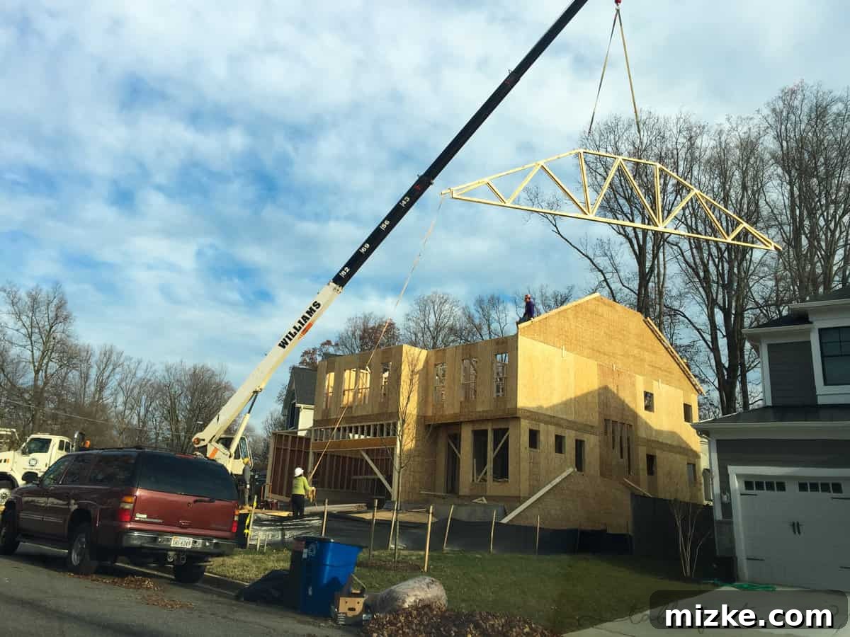 Another angle of the house framing, showing the expanding structure and roof trusses