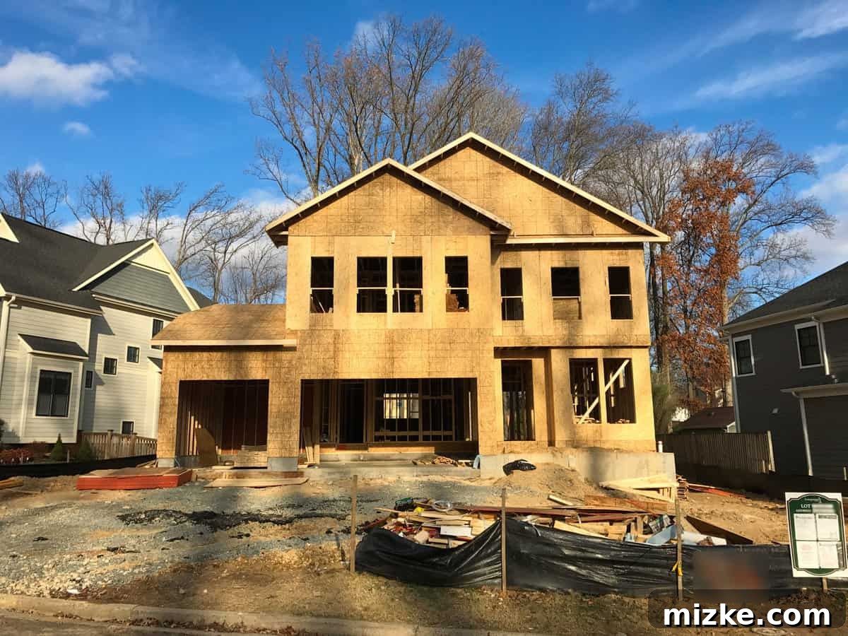 Roof trusses being lifted by a large crane and installed onto the house frame