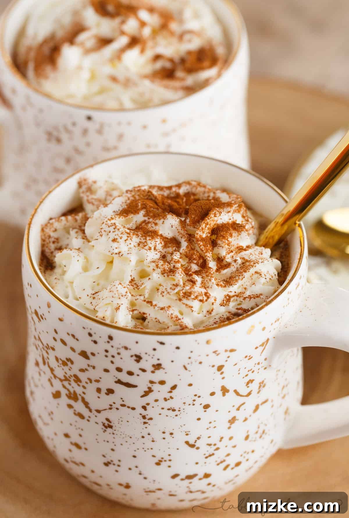 Gingerbread Latte Wonders 2 A steaming mug of rich, extra spicy gingerbread latte, garnished with whipped cream and a sprinkle of cinnamon, photographed to evoke warmth and coziness.