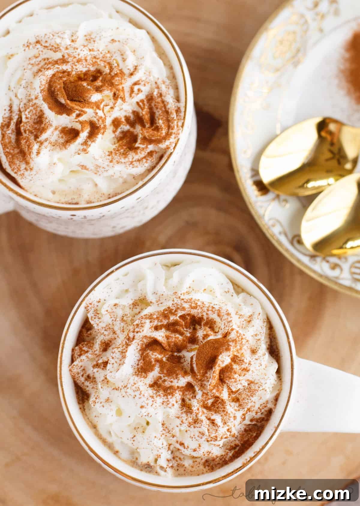 Gingerbread Latte Wonders 3 Overhead shot of two beautifully crafted spicy gingerbread lattes, showcasing their inviting foam and festive appearance, perfect for a chilly day.