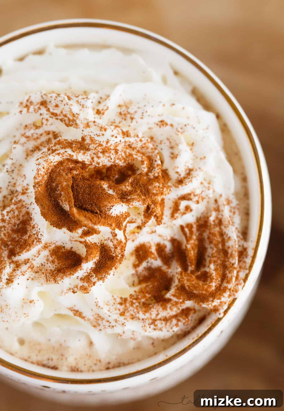 Gingerbread Latte Wonders 4 Close-up of a spicy gingerbread latte, showcasing the rich texture, speckled spices, and delicate foam, highlighting its homemade quality.
