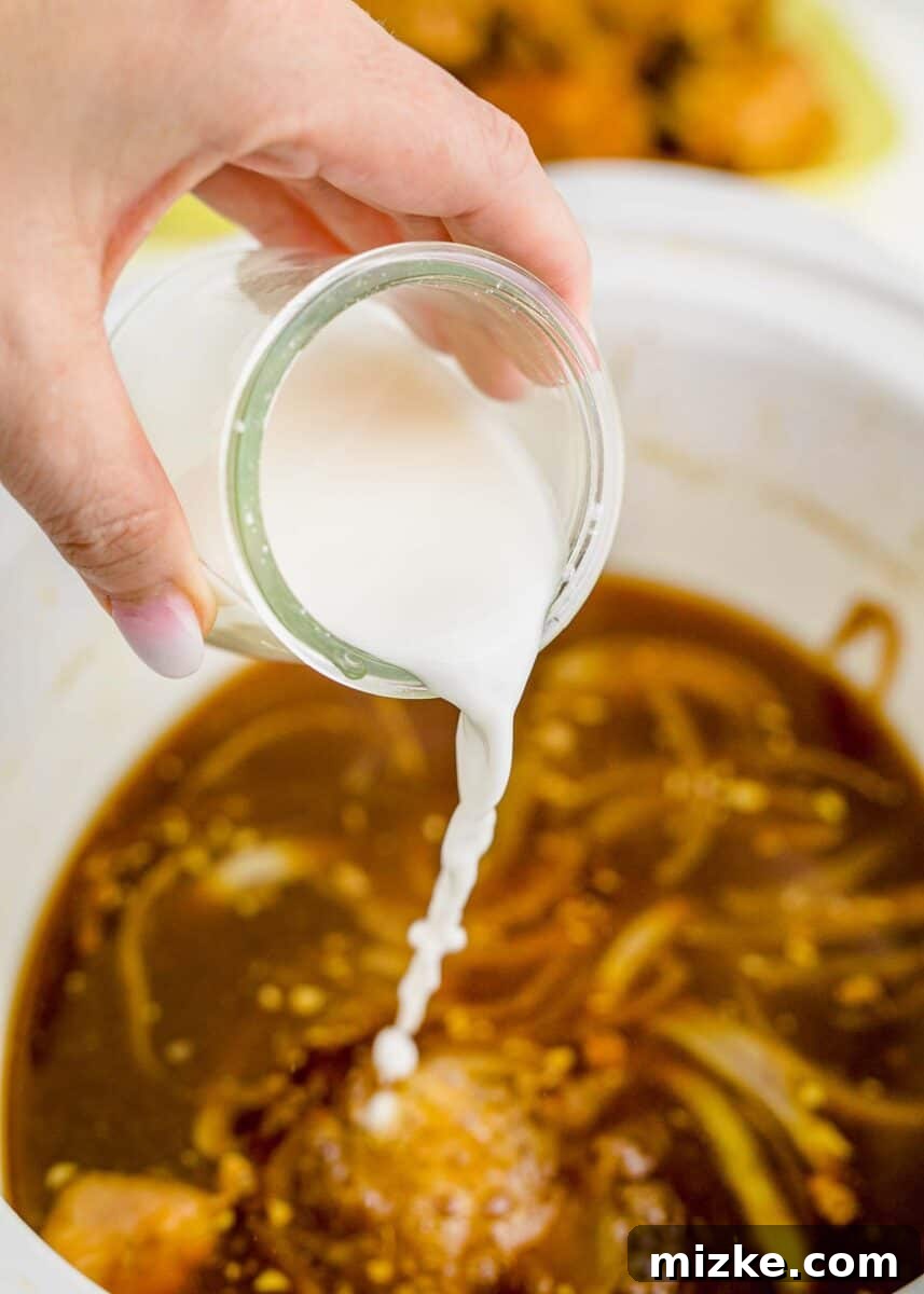 adding the cornstarch slurry to the chicken adobo sauce in the slow cooker