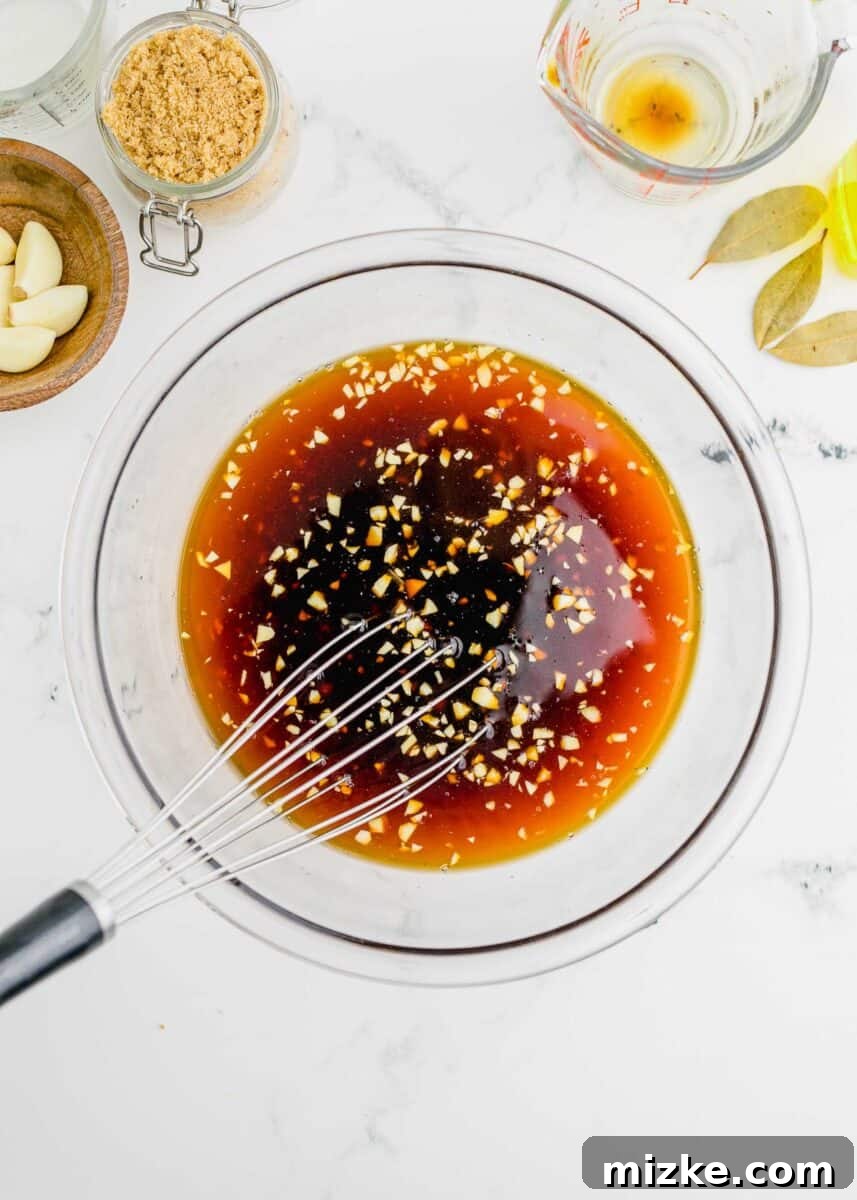 chicken adobo sauce marinade being whisked in a clear bowl