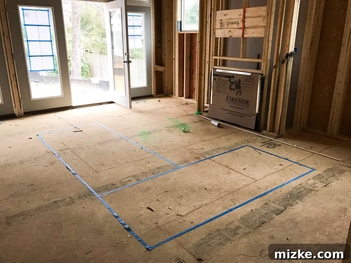 Behind the Walls Unveiled 5 Interior of a new home with a fireplace frame mistakenly placed at ground level, showing blue painter's tape on the floor used for furniture planning.