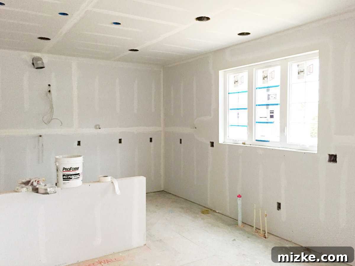 Our Walls Stand Tall 2 Completed drywall installation in a new construction home, showing enclosed rooms and smooth interior surfaces ready for paint