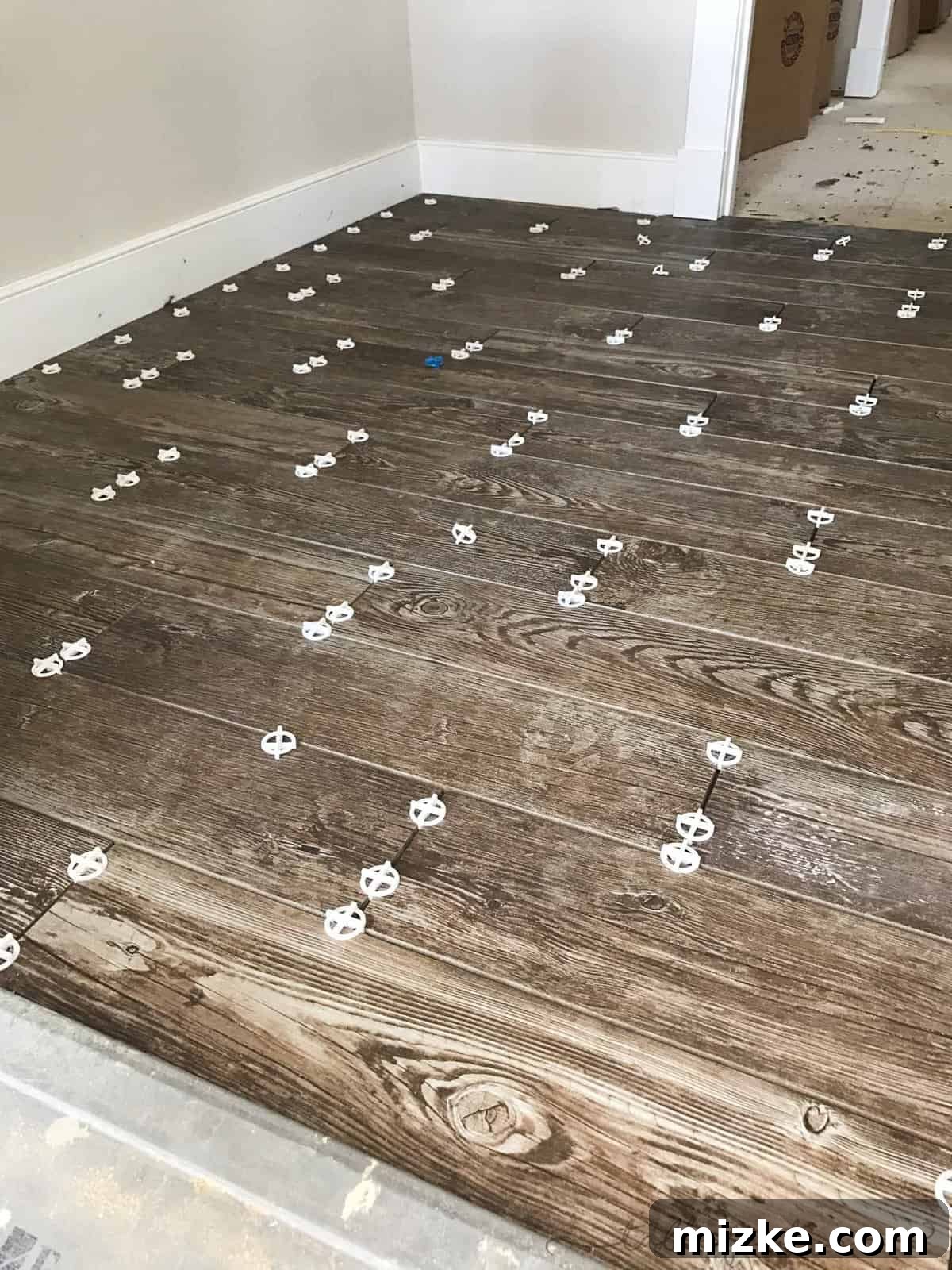 The Final Push 7 Durable wood-look ceramic tile flooring in a mudroom of a new custom home, perfect for high traffic.
