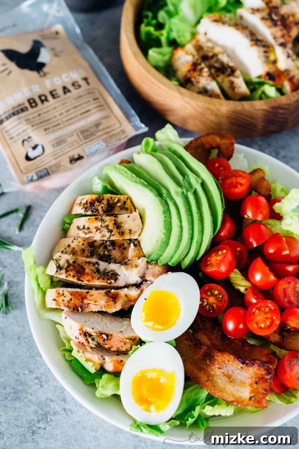 Chargrilled Rosemary Chicken Salad 4 Ingredients laid out for a grilled rosemary chicken salad, including fresh chicken breasts, rosemary, and olive oil.