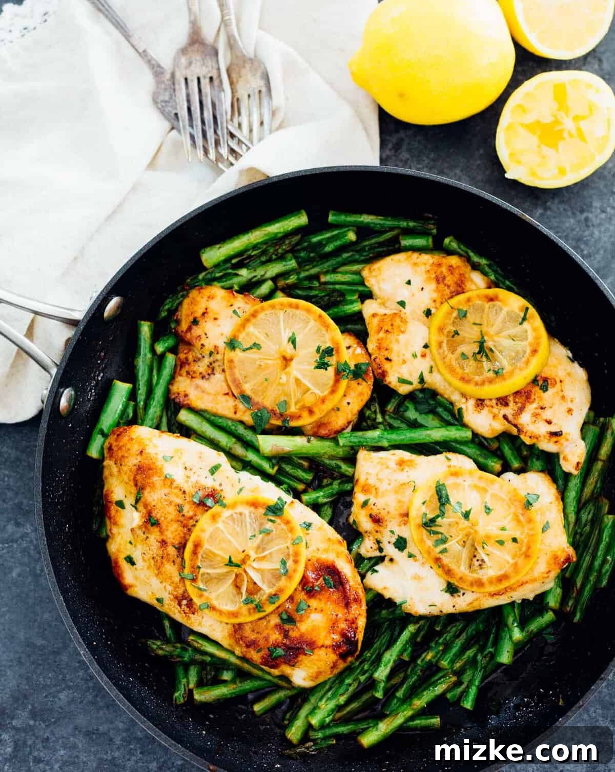 Zesty Honey Butter Chicken with Tender Asparagus 3 Close-up of perfectly cooked Honey Butter Lemon Chicken with tender asparagus.