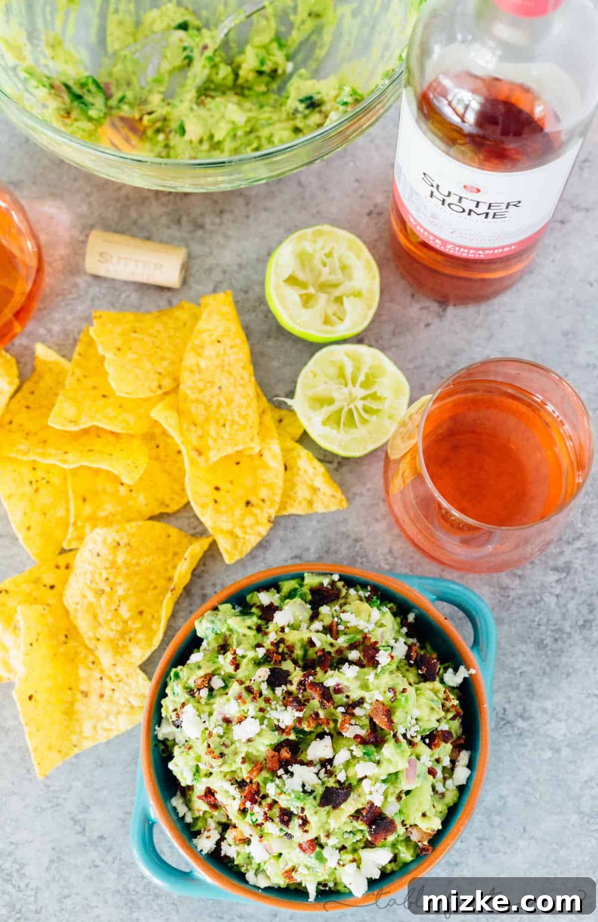 Smoked Poblano and Black Pepper Bacon Guac 4 A beautifully presented bowl of charred poblano and peppered bacon guacamole, ready to be served as the star appetizer at any gathering.