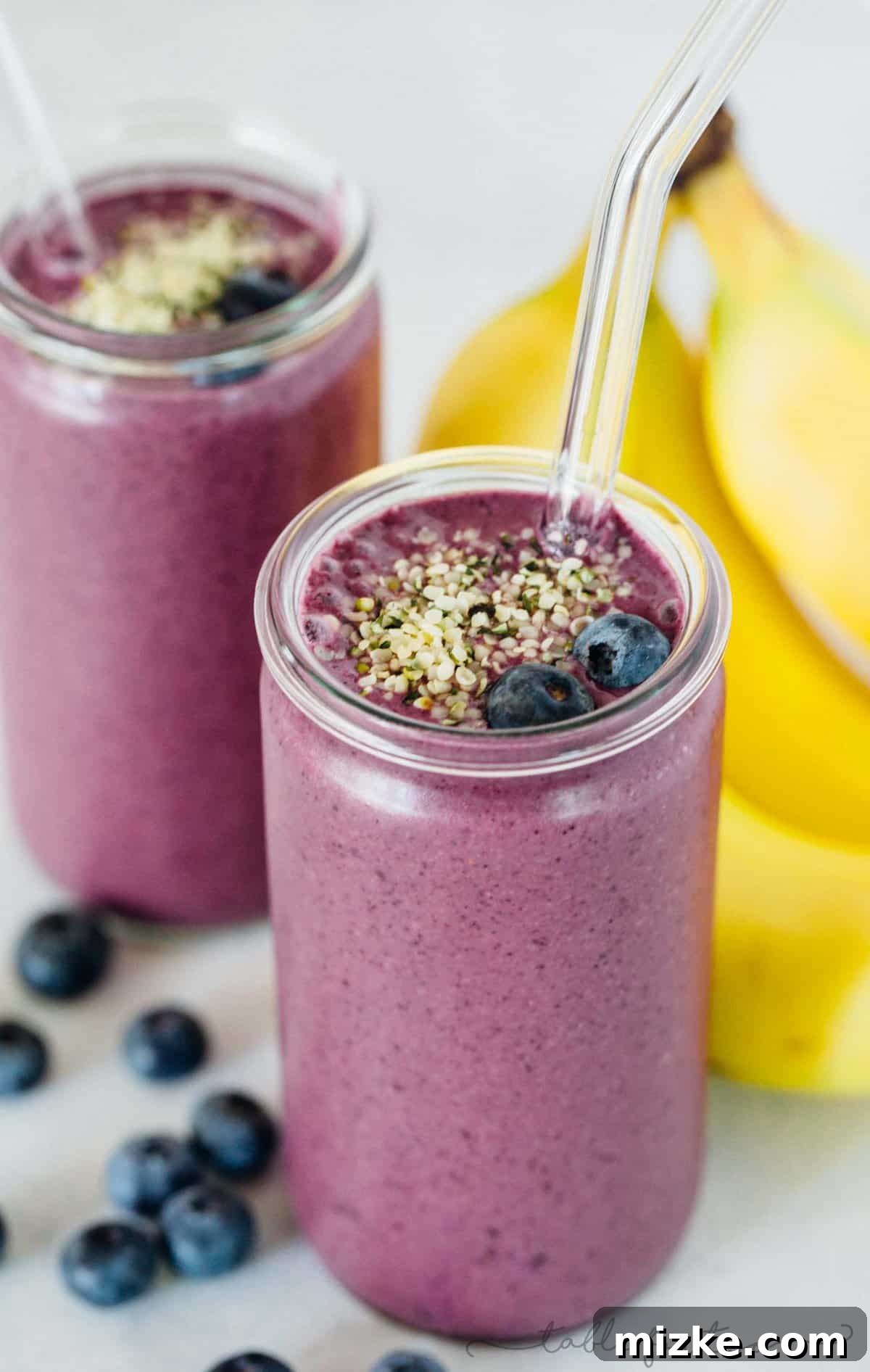 Berry Banana Bliss 3 A close-up of a refreshing blueberry banana smoothie, showcasing its rich purple color and creamy texture. Ideal for a quick, healthy meal or snack.