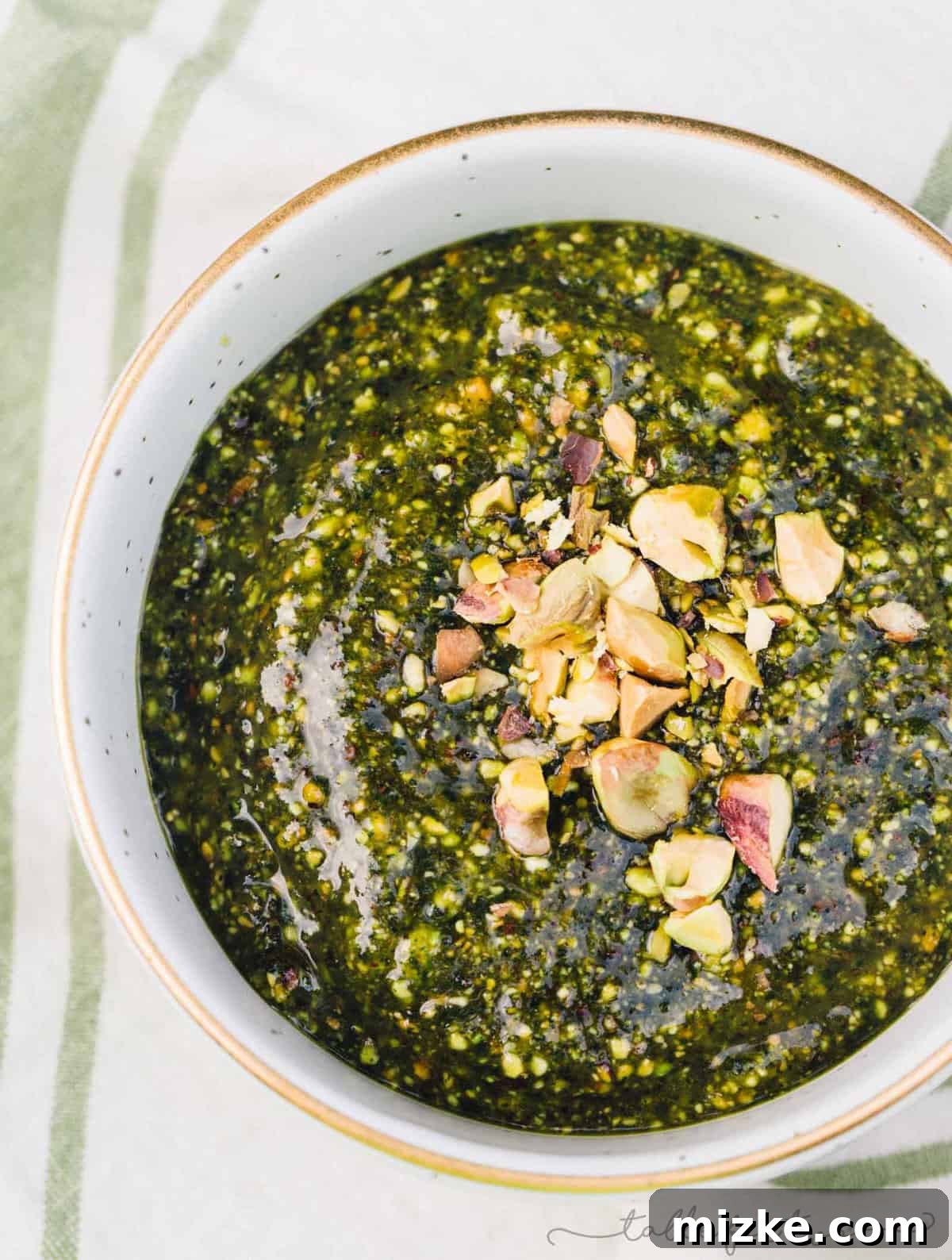Fresh Pistachio Mint Pesto: A Zesty Topping for Grilled Meats and Summer Dishes #pistachio #mint #pesto #grilling #pestorecipes #recipes #foodprocessor Vibrant green pistachio mint pesto served in a small bowl, ready to be enjoyed with grilled dishes, pasta, or as a dip.