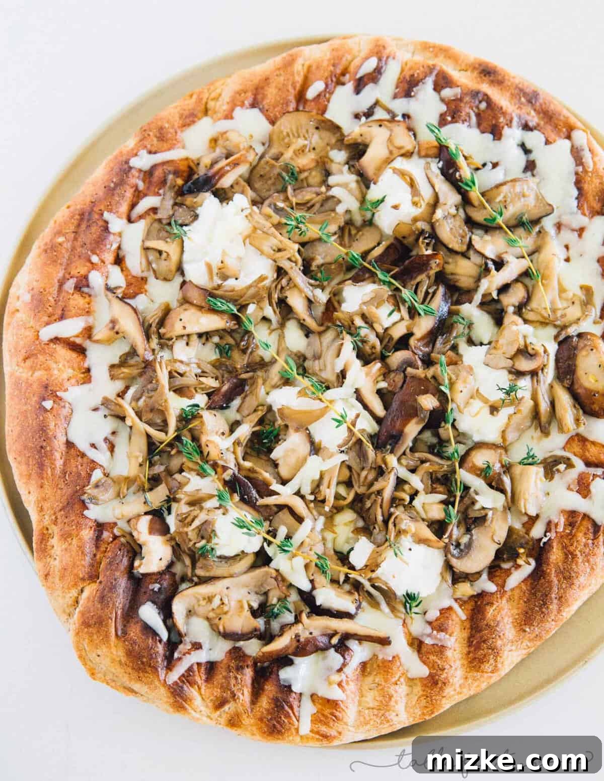Mushroom lovers will be in paradise with this triple mushroom and herb grilled pizza! The earthy and hearty mushrooms on top of this pizza pair perfectly with the creamy ricotta and mozzarella cheese!