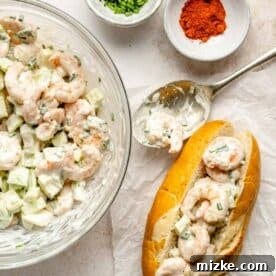 A close-up of the mixed shrimp roll filling next to an assembled shrimp roll, demonstrating the final delicious product.