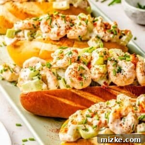 Delicious creamy shrimp rolls presented in a diagonal line on a green plate, highlighting their fresh and inviting appearance.
