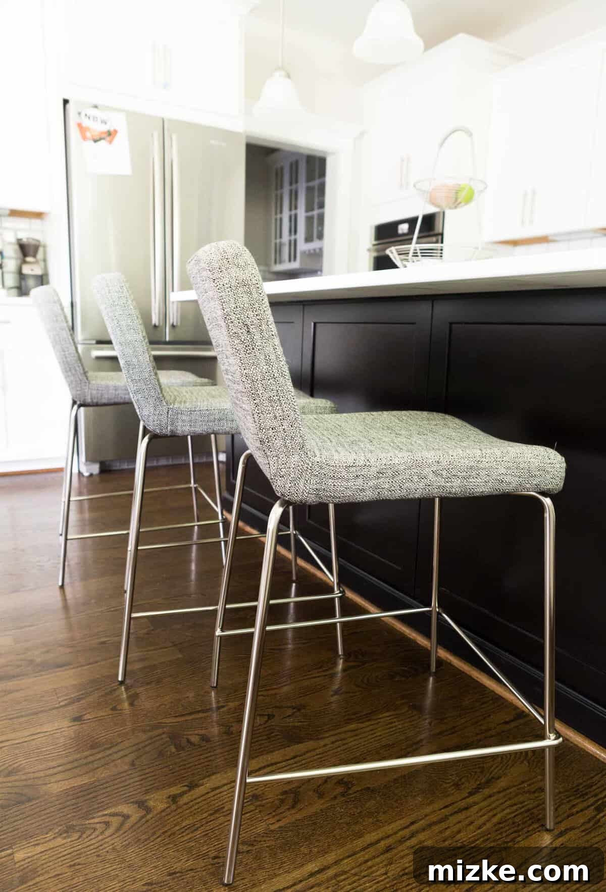 Welcome to My Kitchen 12 Stylish and comfortable counter stools with backs at a large kitchen island, designed for dining and socializing.