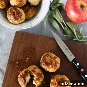 Autumn Harvest Chicken Meatballs with Apple Sage and a Cheesy Core 7 Cooked chicken apple and sage meatballs on a baking sheet, fresh from the oven