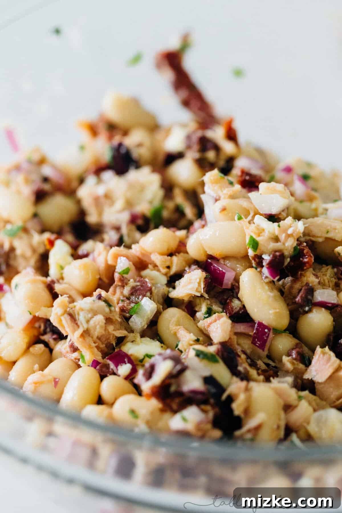 Bright Mediterranean Tuna & White Bean Salad 4 Close-up of mixed ingredients in the Mediterranean tuna white bean salad, highlighting the vibrant colors and textures.