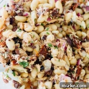 A vibrant bowl of Mediterranean tuna white bean salad, ready to be served.