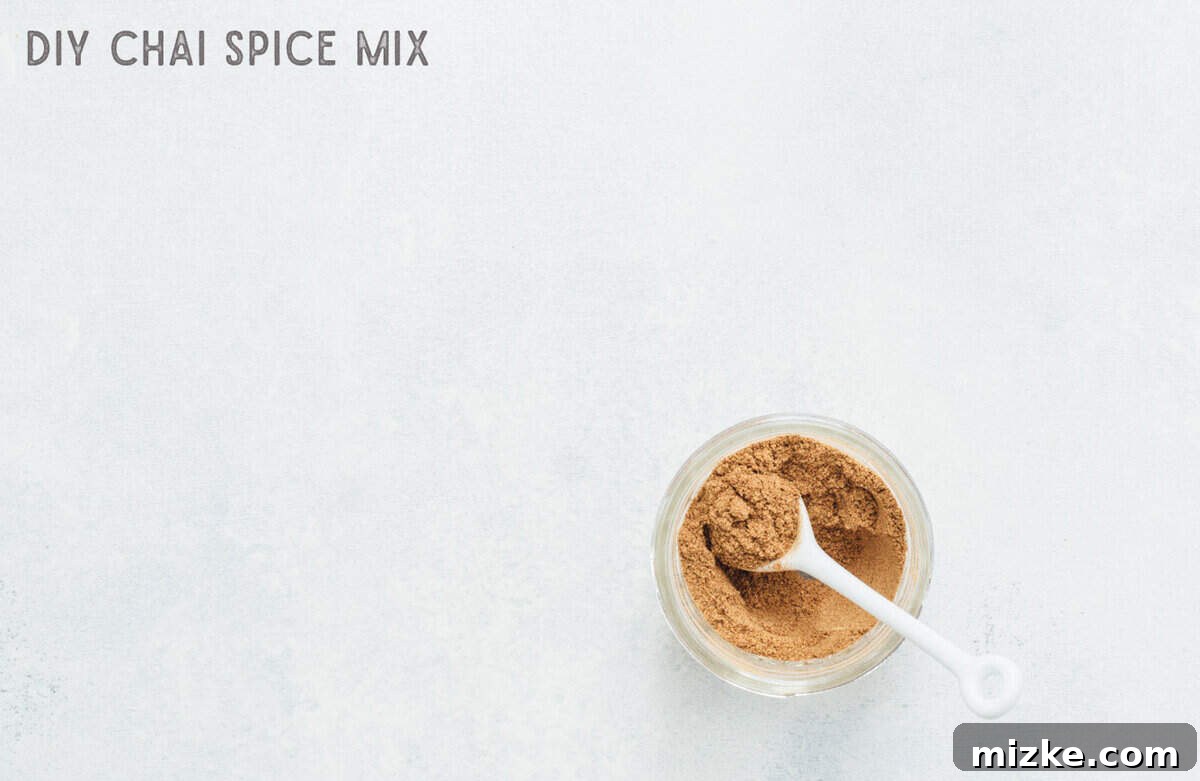 Your Signature Chai Spice Mix 2 A beautifully arranged mason jar filled with a freshly prepared homemade chai spice blend, ready for use in countless fall and winter recipes and drinks. The rich, warm colors of the spices evoke comfort and coziness.
