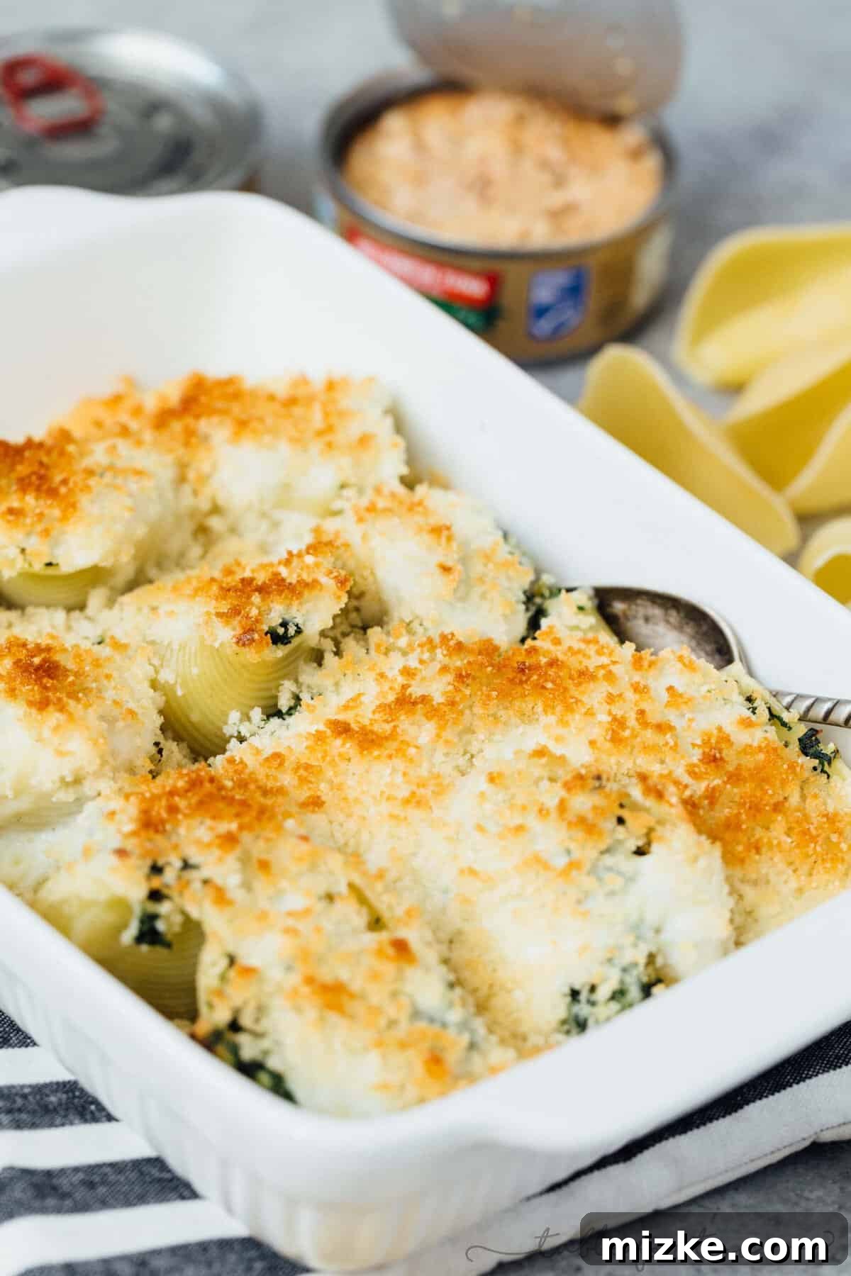 Tuna and Spinach Shell Bake 5 Neatly arranged rows of filled pasta shells in a baking dish, ready for sauce and baking.