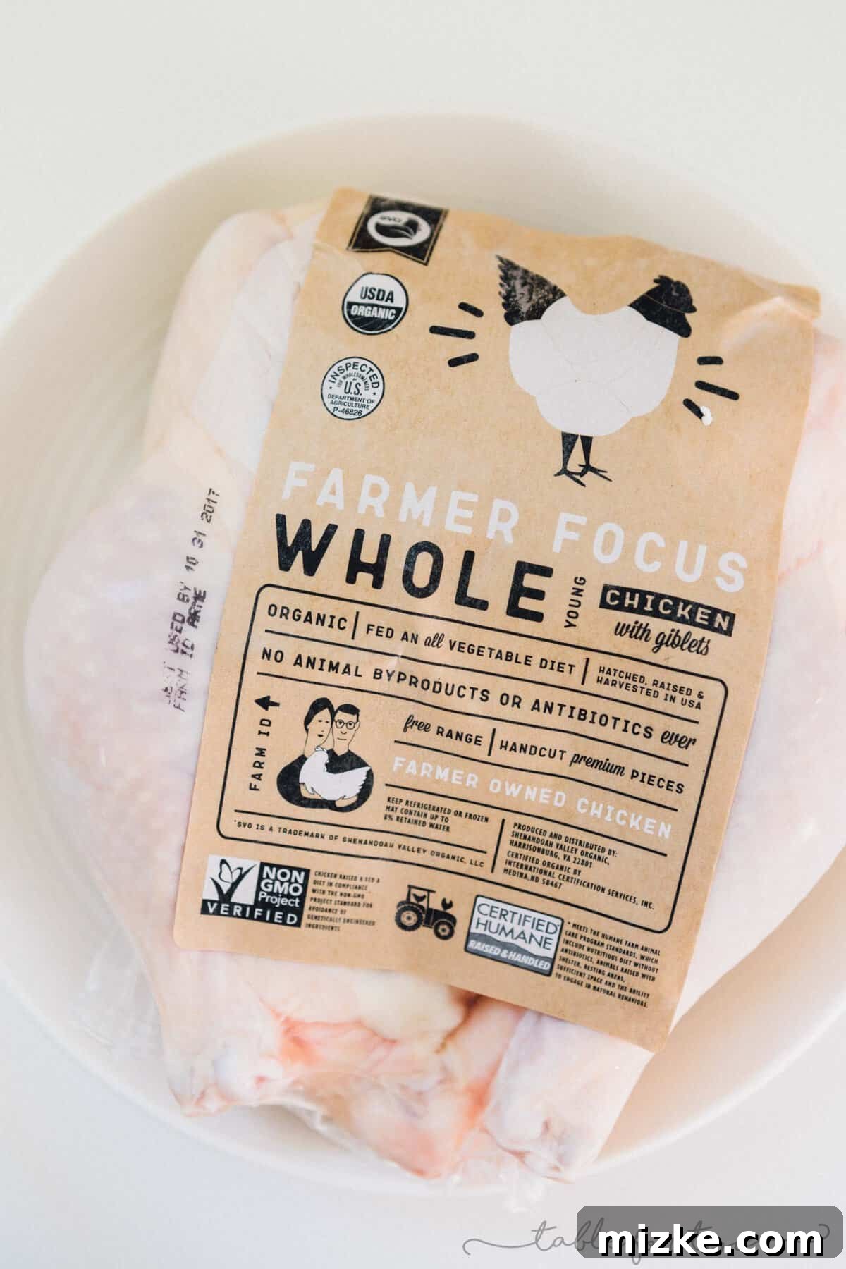 Honey Butter Herb Roasted Pressure Cooker Chicken 3 A whole, raw Shenandoah Valley Organic chicken, seasoned with salt and pepper, placed on a cutting board, ready for pressure cooking, ensuring maximum flavor.