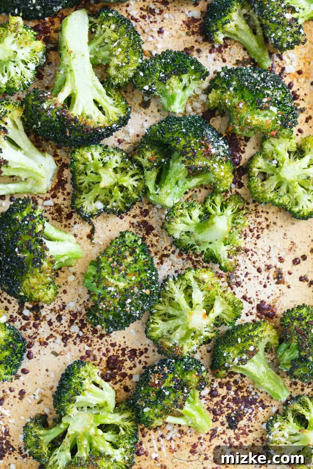 Parmesan-Crusted Roasted Broccoli 4 Freshly grated Parmesan cheese generously sprinkled over green broccoli florets on a baking sheet before roasting for a cheesy delight.
