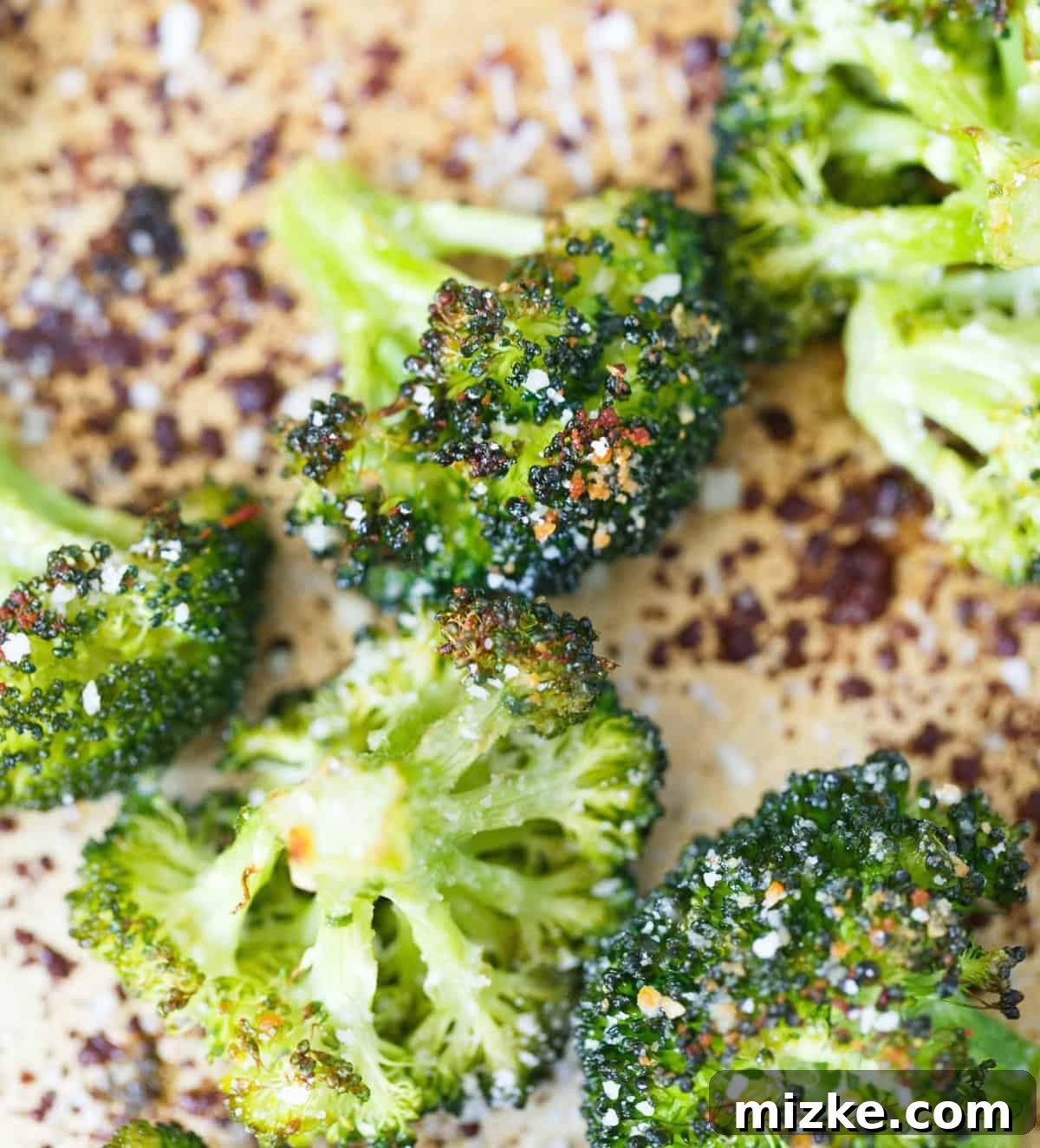 Parmesan-Crusted Roasted Broccoli 5 A large baking sheet filled with perfectly roasted parmesan broccoli, steam gently rising, showcasing its readiness to be served.