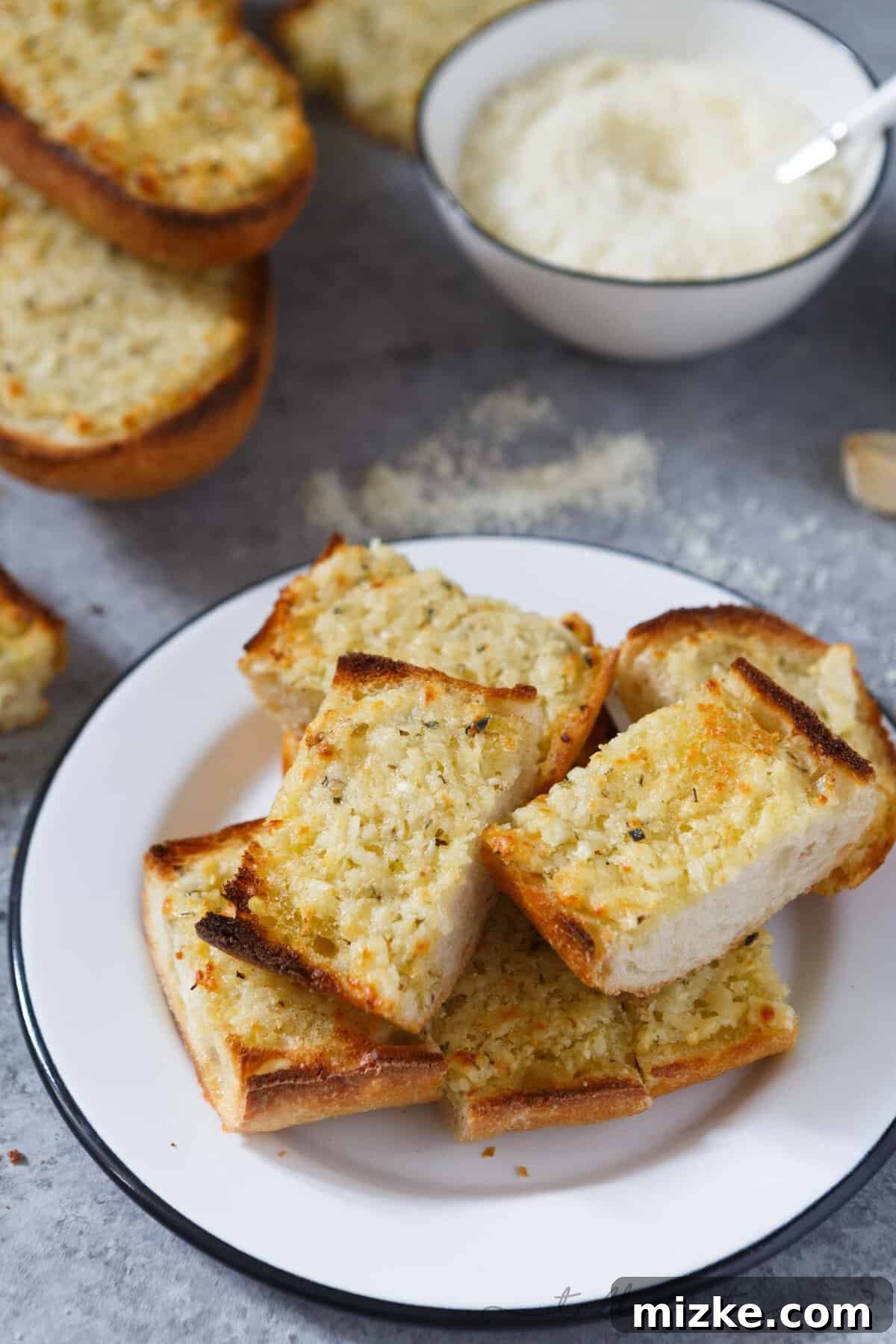 Epic Garlic and Parmesan Cheese Bread 2 Crispy, golden-brown extra garlicky and cheesy bread slices, perfectly baked and ready to be served.