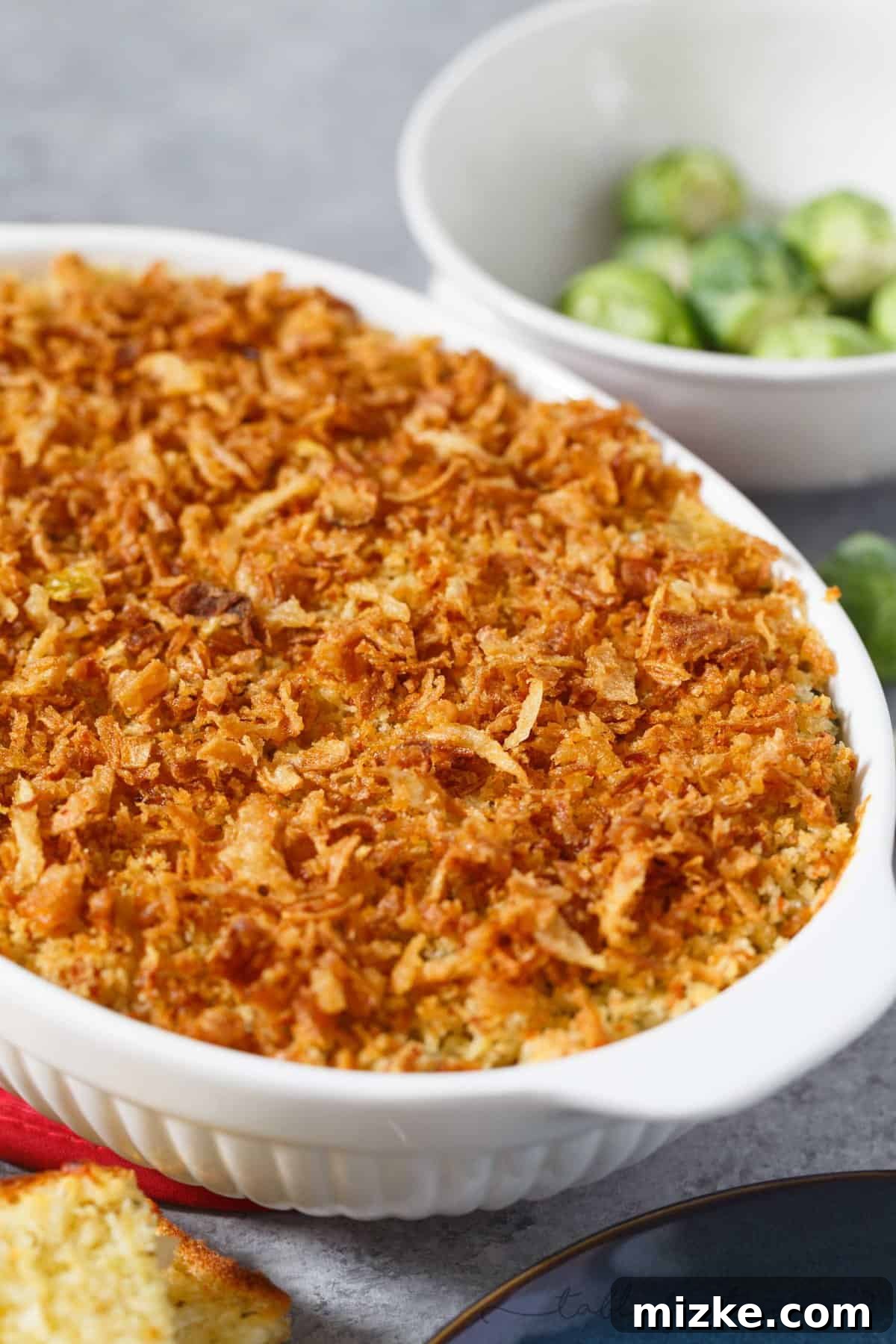 Golden Roasted Brussels Sprouts Gratin 3 Close-up of the roasted Brussels sprouts gratin, highlighting the irresistible texture of the crispy garlic crumble and fried onion topping.