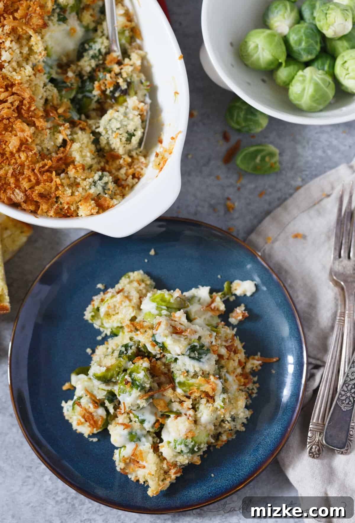 Golden Roasted Brussels Sprouts Gratin 4 A generous serving of roasted Brussels sprouts gratin on a plate, showing the creamy interior and golden-brown, crunchy topping.