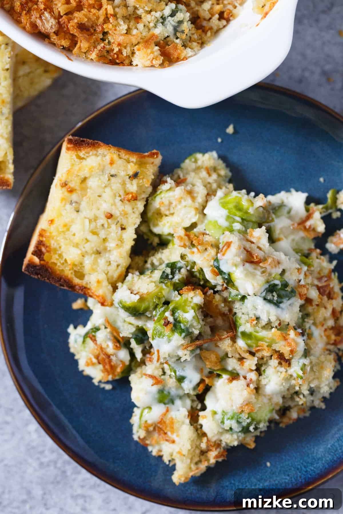 Golden Roasted Brussels Sprouts Gratin 6 The finished Brussels sprouts gratin in a baking dish, with steam gently rising, promising warmth and deliciousness.