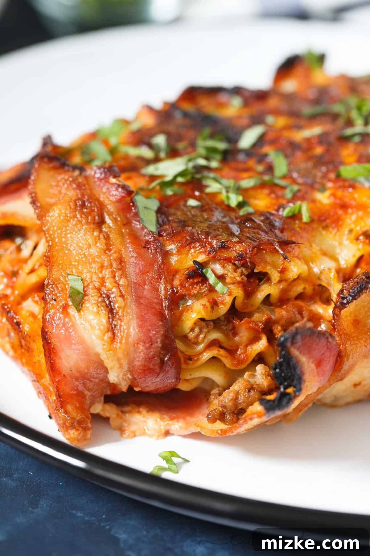 Bacon Blanket Lasagna Bake 3 Close-up of Bacon Wrapped Lasagna, showing the crispy bacon exterior and cheesy layers within.