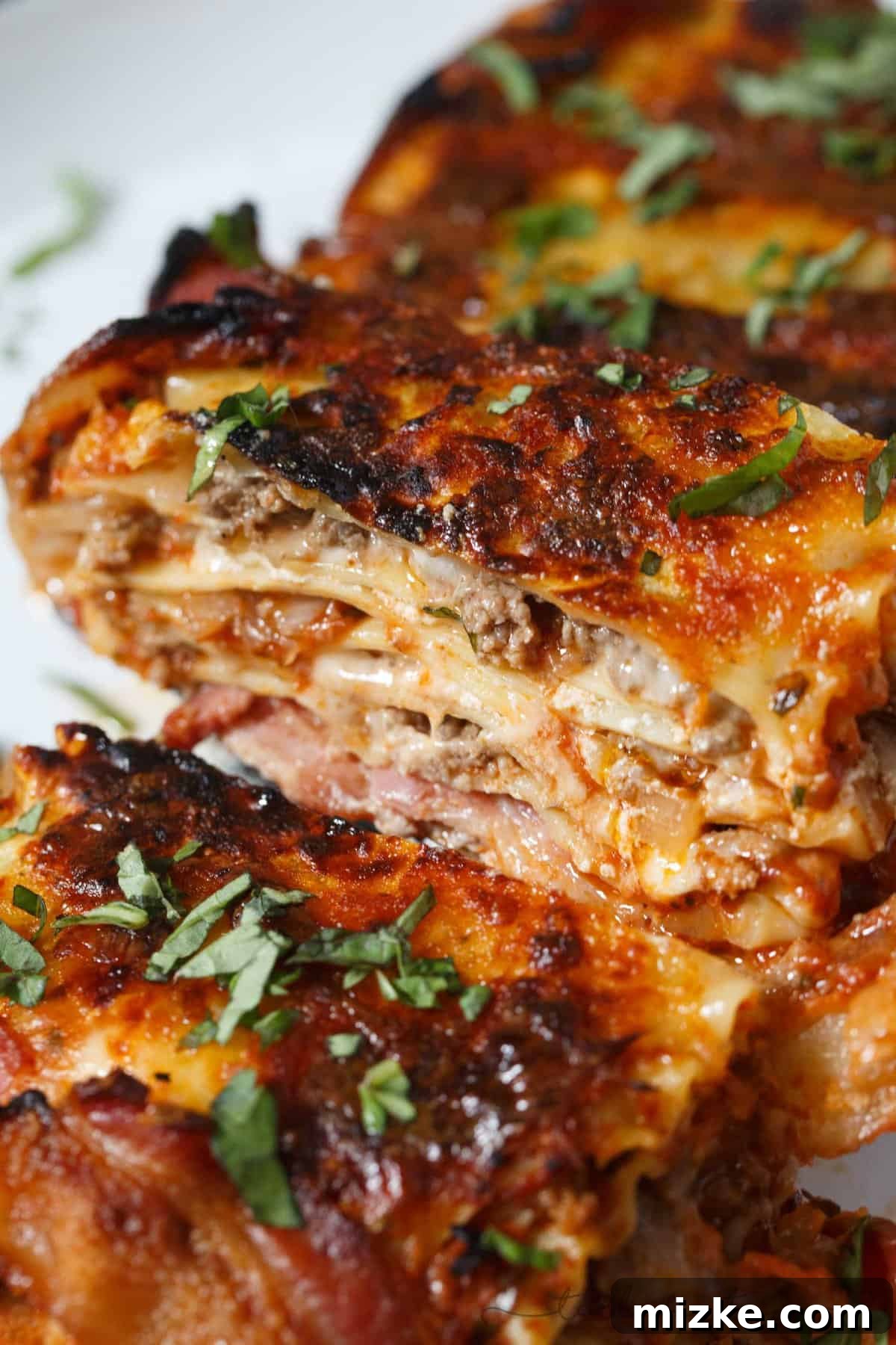 Bacon Blanket Lasagna Bake 4 A slice of Bacon Wrapped Lasagna, showcasing the rich layers of pasta, cheese, and meat sauce.