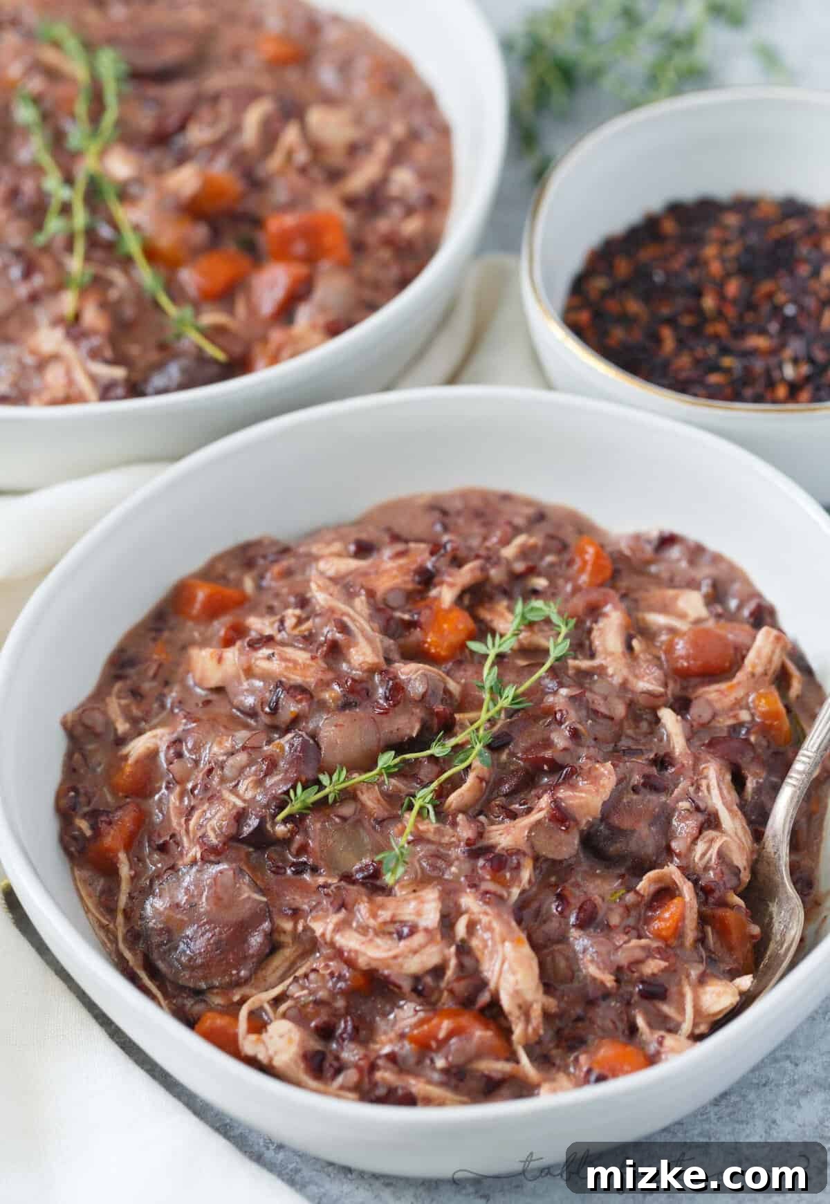 Velvety Instant Pot Chicken Mushroom Wild Rice Stew 2 A comforting bowl of creamy mushroom and chicken wild rice stew, garnished with fresh herbs, perfect for warming up on a chilly day.