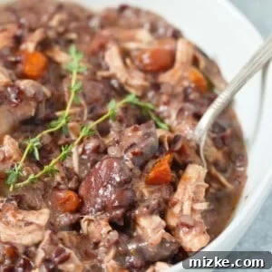 Instant Pot Creamy Mushroom and Chicken Wild Rice Stew served in a rustic bowl.