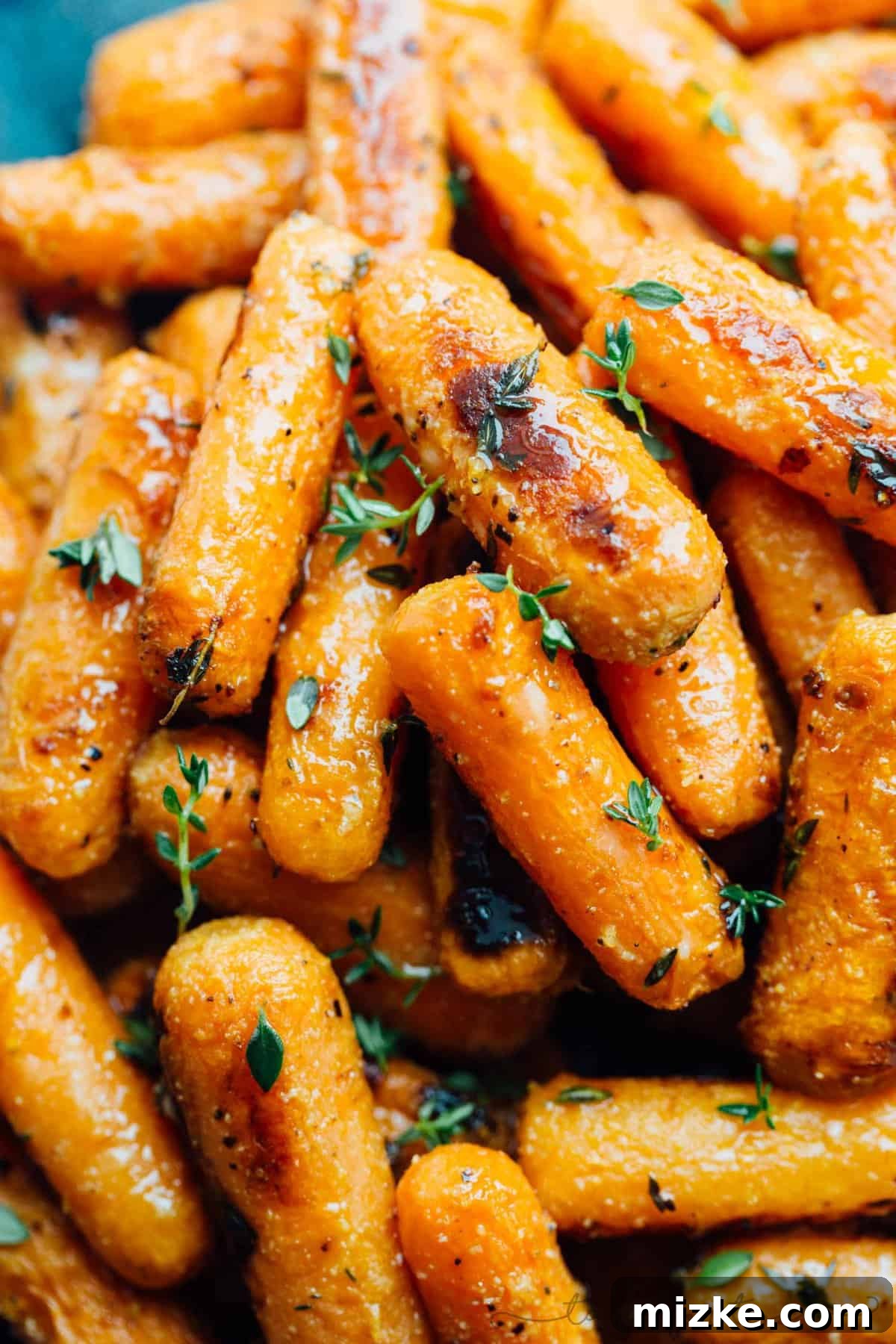 Parmesan Crusted Roasted Carrots 3 A vibrant platter of roasted baby carrots, perfectly browned with melted parmesan and aromatic herbs, appealing to all carrot skeptics.